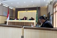 Suasana persidangan, Kuasa Hukum terdakwa, Ach. Suhairi terlihat membaca berkas perkara sebelum sidang dimulai. 