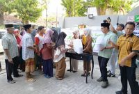 Kepala cabang Alamanda Pamekasan saat memberikan sembako kepada warga 